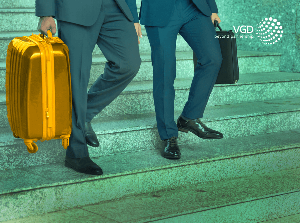 businessmen wearing suits with a gold suitcase