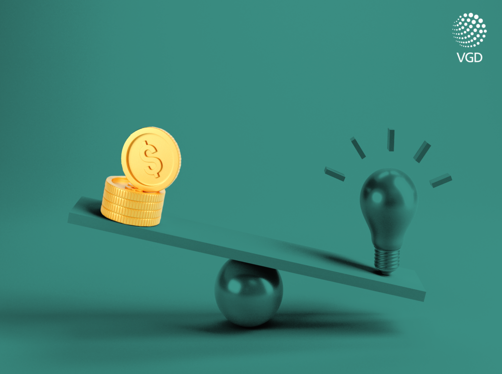 green light bulb and money on a balance scale