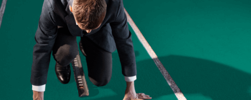 a man wearing a suit is getting ready for a run