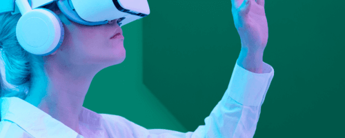 a woman wearing virtual reality goggles on green background